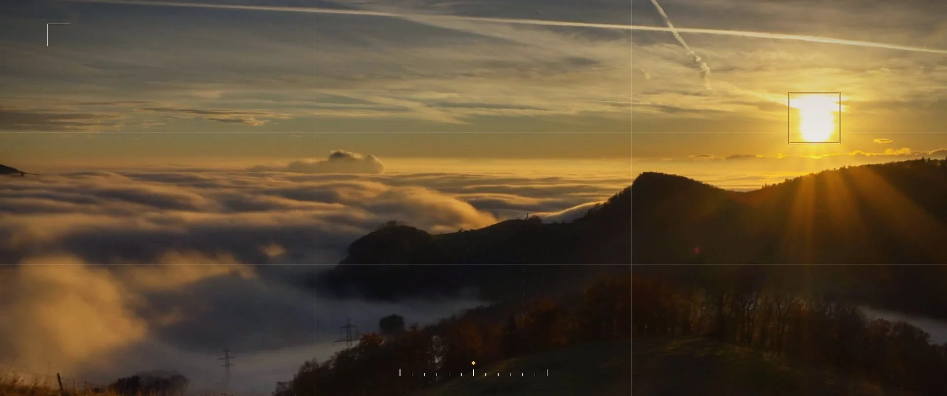 Camera viewfinder over a sea of clouds, with the autofocus box locked on the sun