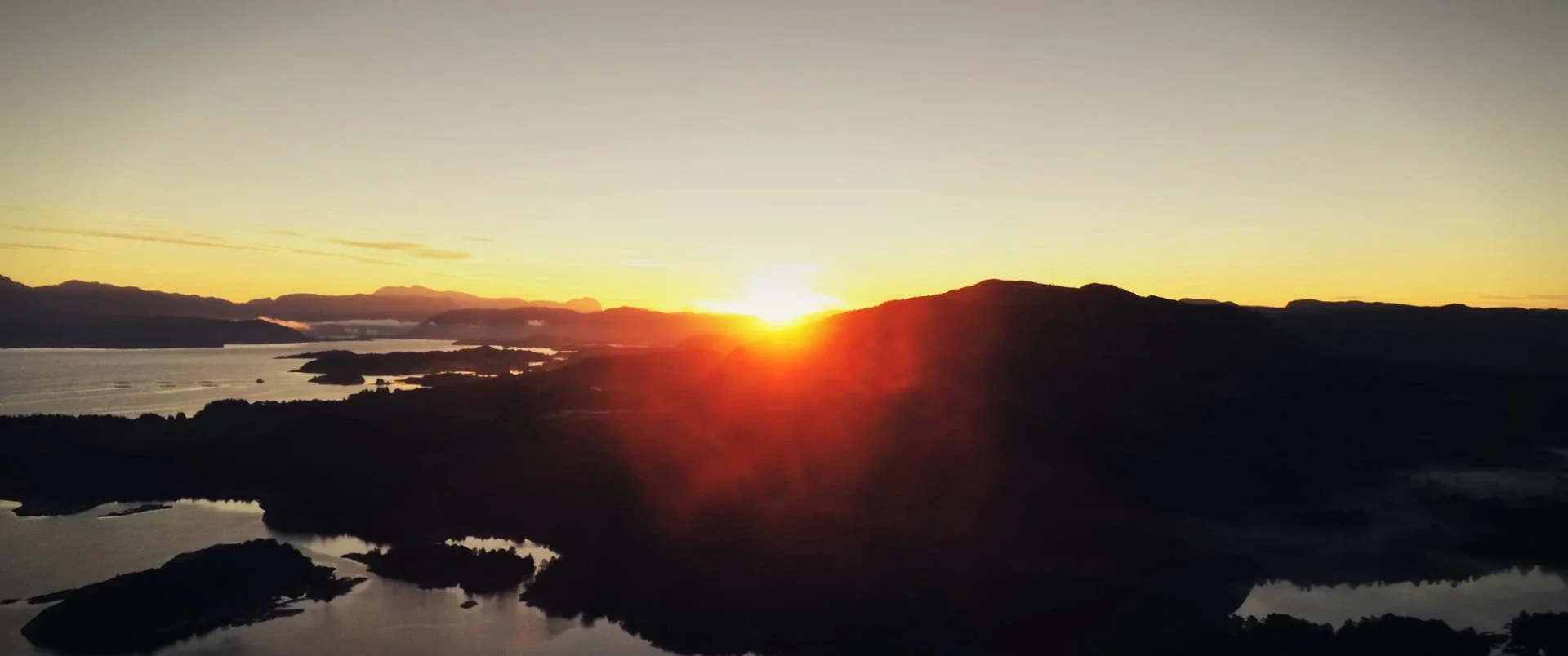 Sunrise over a lake with islands, from above